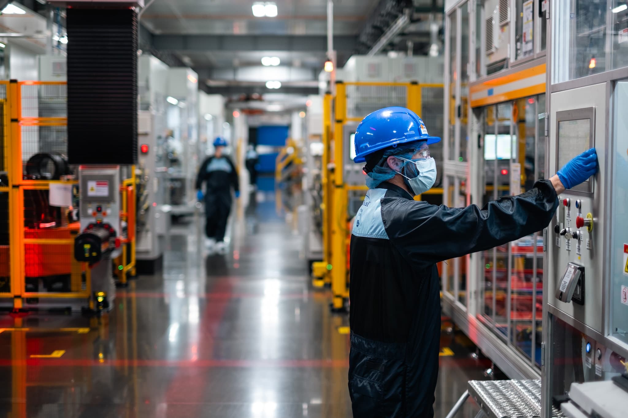 Ford employee operating battery production equipment at BlueOval Battery Park Michigan